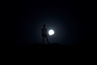 Silhouette man standing at night