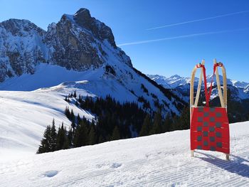 Scenic view of snow covered mountains against sky