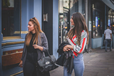 Young woman with people walking in city