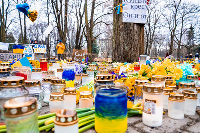 Thousands candles and flowers standing on the street during the war in ukraine