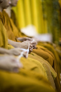 Monk in yellow doing some ritual or meditation