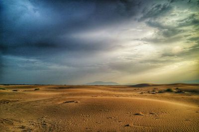 Scenic view of landscape against cloudy sky