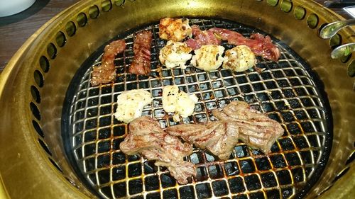 High angle view of meat on barbecue