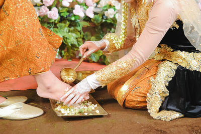 Midsection of woman holding umbrella