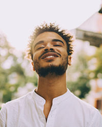 Portrait of smiling young man in casuals during sunny day