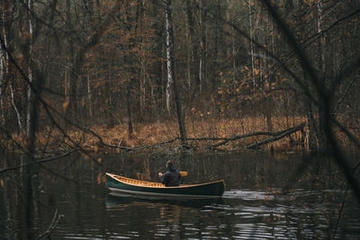 Rear view of man boating in lake