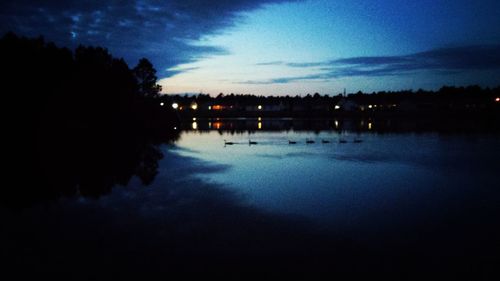 Scenic view of lake against sky at night