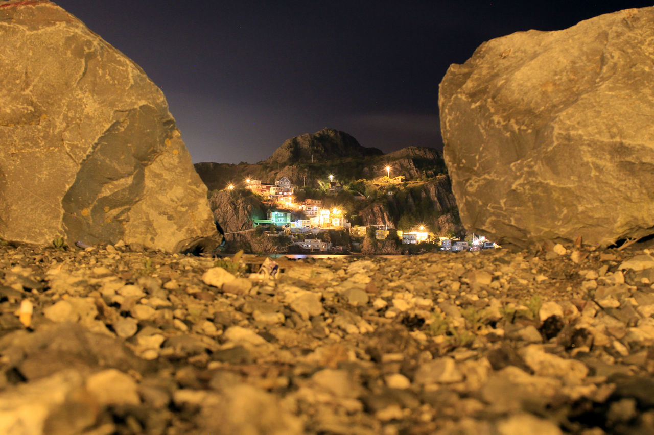 night, rock - object, water, illuminated, rock formation, rock, nature, mountain, stone - object, tranquility, scenics, tranquil scene, surface level, beauty in nature, outdoors, sky, no people, travel destinations, landscape, idyllic