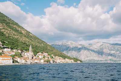 Scenic view of sea and mountains against sky