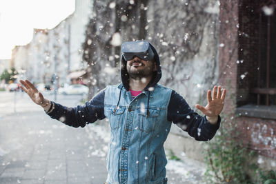 Man wearing virtual reality simulator with cottonwood fluff in mid-air