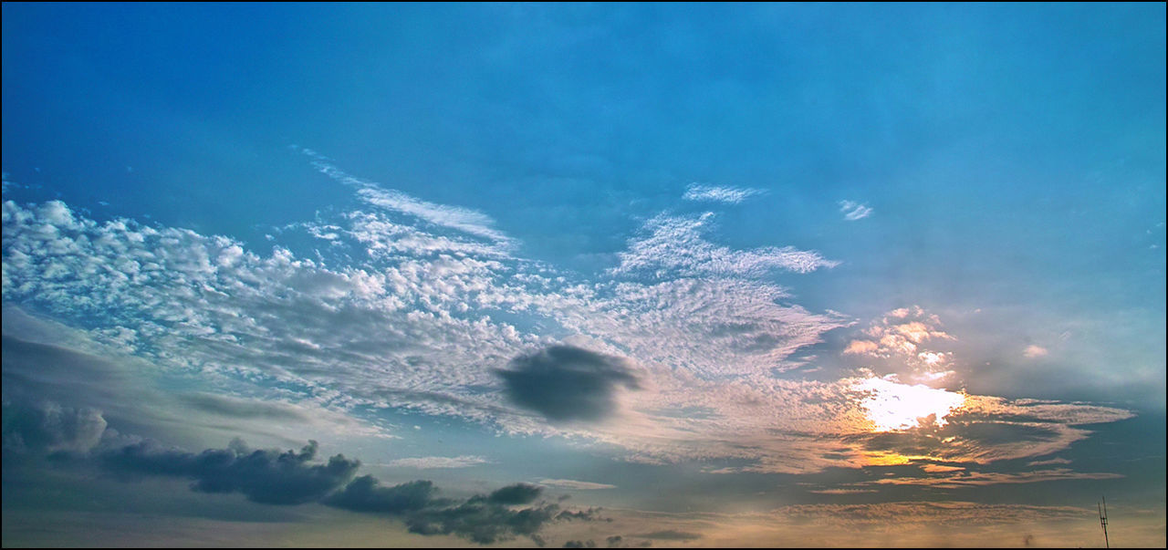 sky, scenics, tranquil scene, tranquility, beauty in nature, sunset, sun, cloud - sky, nature, idyllic, blue, sunlight, low angle view, sunbeam, cloud, outdoors, silhouette, no people, sea, water