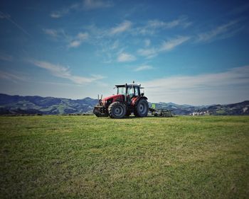 Tractor on field against sky