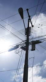 Low angle view of electricity pylon against sky