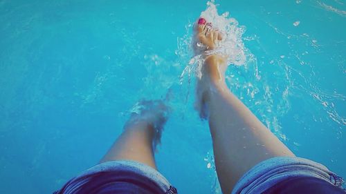 Low section of woman standing in water