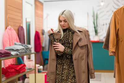 Young woman looking away while standing in store