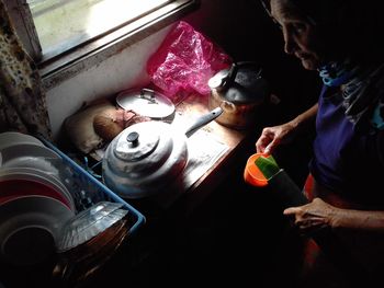 High angle view of woman preparing food in kitchen at home