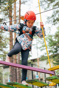 Low angle view of woman standing on rope