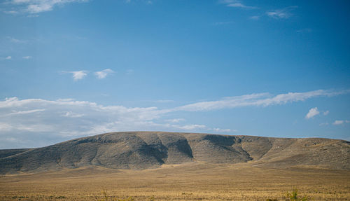 Scenic view of arid landscape against sky