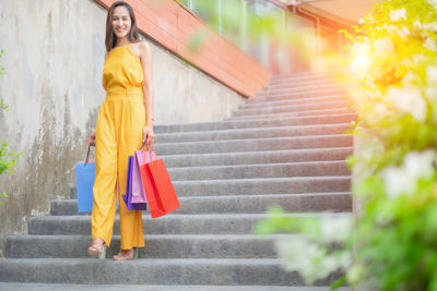 Full length of woman standing on staircase