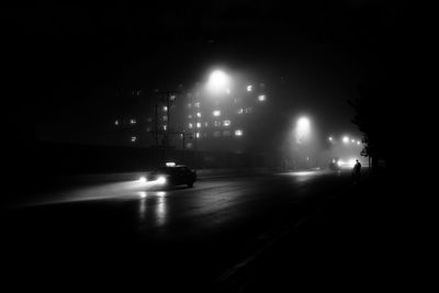 Cars on road in city at night