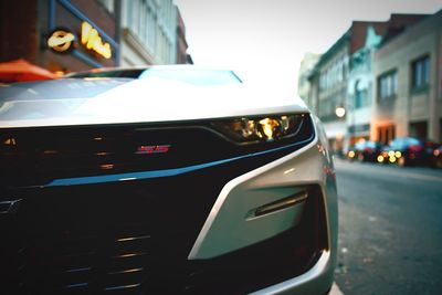 Close-up of car on city street at night