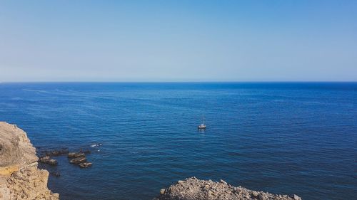 Scenic view of sea against clear blue sky