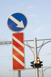 Road sign against sky