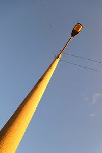 Low angle view of street light against clear blue sky