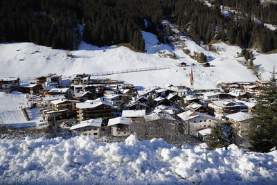 High angle view of snow covered field by building