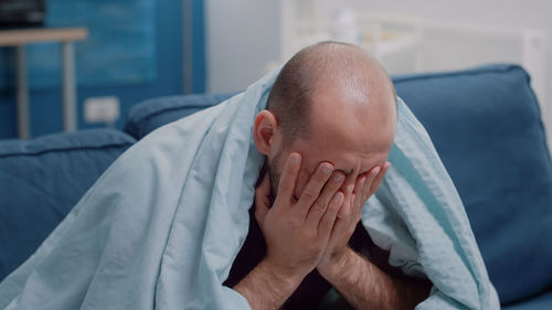 Midsection of man resting at home