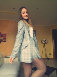 Portrait of woman standing at home