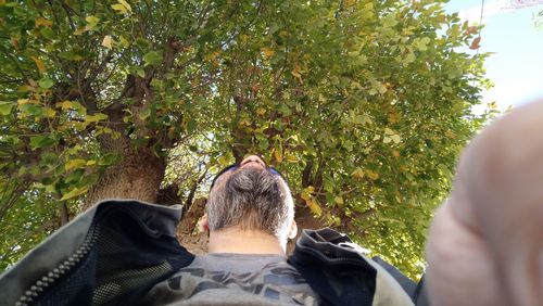 Rear view of woman against plants