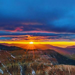 Scenic view of dramatic landscape during sunset