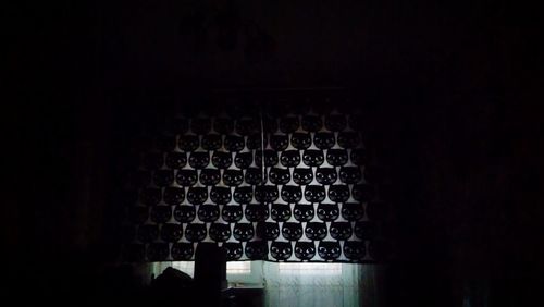 Full frame shot of beer bottles in dark room