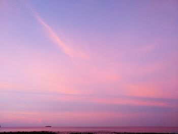 Scenic view of sea against dramatic sky during sunset