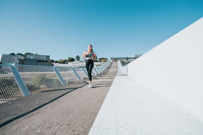 Female athlete running on steps