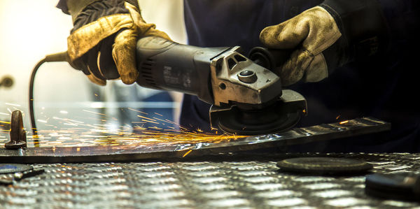 Midsection of worker working in workshop