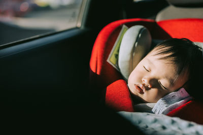 Cute boy sleeping in car