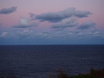 Scenic view of sea against sky at dusk
