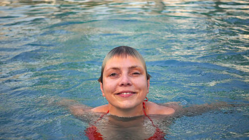 Portrait of smiling girl swimming in pool