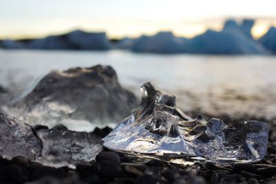 Close-up of rocks on shore during sunset