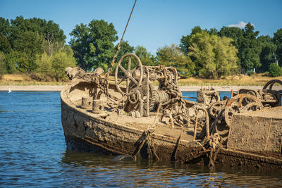 Scenic view of a wreck in the river against sky