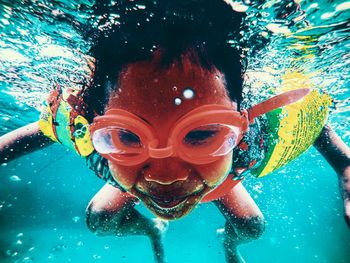 Portrait of boy swimming underwater