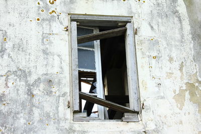 Abandoned building seen through broken window