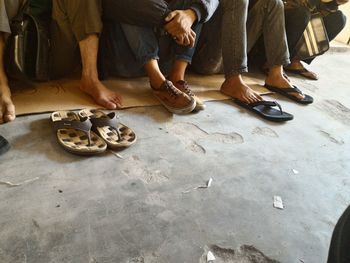 Low section of men sitting on floor