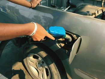 Cropped hand refueling car