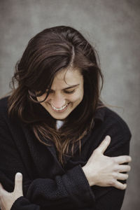 Happy woman with eyes closed standing outdoors