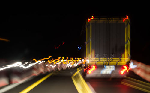Close-up of light trails on road at night
