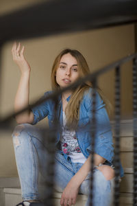 Portrait of young woman sitting at home