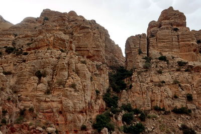 Low angle view of rock formations against sky